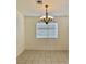 Bright dining area with tile flooring, a modern chandelier, and a window for natural light at 2050 N Los Feliz St # 114, Las Vegas, NV 89156