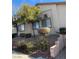 Exterior view of the building with unit number and desert landscaping, offering a blend of comfort and style at 2050 N Los Feliz St # 114, Las Vegas, NV 89156