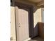Close up of the front door, displaying the unit number and neutral color, set in stucco with tan trim at 2050 N Los Feliz St # 114, Las Vegas, NV 89156