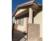 Inviting front porch featuring a secure, tan-colored block-wall surrounding the entry with stone flooring at 2050 N Los Feliz St # 114, Las Vegas, NV 89156