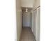 Hallway with tiled floor and bright lighting, including a white door and louvered closet at 2050 N Los Feliz St # 114, Las Vegas, NV 89156
