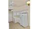 Bright kitchen featuring white appliances and cabinets, with tile countertops, and tile flooring at 2050 N Los Feliz St # 114, Las Vegas, NV 89156