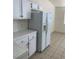 View of the kitchen featuring white appliances, cabinets, countertops, and tile flooring at 2050 N Los Feliz St # 114, Las Vegas, NV 89156
