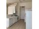 Kitchen with white cabinets, tile countertops, modern appliances, and tile flooring at 2050 N Los Feliz St # 114, Las Vegas, NV 89156
