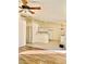 Open living space with a kitchen view, ceiling fan, and blending flooring types at 2050 N Los Feliz St # 114, Las Vegas, NV 89156