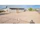 Wide backyard with desert landscaping and a charming single-story house at 211 Kansas Ave, Henderson, NV 89015