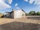 Exterior rear view of home with gray siding and desert landscaping at 211 Kansas Ave, Henderson, NV 89015