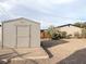 Backyard featuring detached storage shed, desert landscaping, and single-story house at 211 Kansas Ave, Henderson, NV 89015