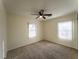Bedroom featuring neutral walls, carpet flooring, ceiling fan and windows with light filtering at 211 Kansas Ave, Henderson, NV 89015