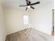 Bedroom showcasing neutral walls, carpet flooring, and ceiling fan providing comfort at 211 Kansas Ave, Henderson, NV 89015