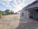 Exterior side view of home with gray siding, desert landscaping, and blue sky at 211 Kansas Ave, Henderson, NV 89015