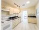 Well-lit kitchen with white appliances, stylish black marble-style countertops, and ample storage space at 211 Kansas Ave, Henderson, NV 89015