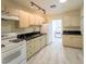 Functional kitchen with white appliances and black marble-style counters, ready for your culinary creations at 211 Kansas Ave, Henderson, NV 89015