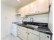 Close-up of a functional kitchen area, featuring marble-style countertops and a range stove at 211 Kansas Ave, Henderson, NV 89015