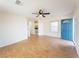 Inviting living room featuring a ceiling fan and an inviting blue front door at 211 Kansas Ave, Henderson, NV 89015