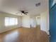 Bright living room with hardwood floors, a ceiling fan, and large windows that let in natural light at 211 Kansas Ave, Henderson, NV 89015