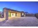 An open backyard features desert landscaping, a covered patio, and sliding glass doors at 2194 Pigeon Hawk St, Las Vegas, NV 89138