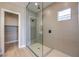 Walk-in shower featuring stylish tile, rainfall shower head, and a small window at 2194 Pigeon Hawk St, Las Vegas, NV 89138