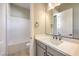 Bathroom featuring a shower and tub, modern vanity, and a neutral palette at 2194 Pigeon Hawk St, Las Vegas, NV 89138