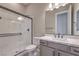 Bathroom featuring a shower with glass doors, white tile, a sleek toilet, and modern vanity at 2194 Pigeon Hawk St, Las Vegas, NV 89138