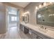 Hall bathroom featuring dual vanities, a neutral palette, and light wood floors at 2194 Pigeon Hawk St, Las Vegas, NV 89138