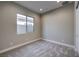 This bedroom offers soft carpet, neutral walls, and a bright window at 2194 Pigeon Hawk St, Las Vegas, NV 89138