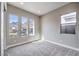 Bright bedroom with three windows and neutral gray walls and carpet at 2194 Pigeon Hawk St, Las Vegas, NV 89138