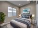 Modern bedroom with an area rug, a decorative painting, and bedside tables at 2194 Pigeon Hawk St, Las Vegas, NV 89138