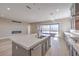 Open kitchen featuring an island, stainless appliances and a sliding glass door to the outdoor living area at 2194 Pigeon Hawk St, Las Vegas, NV 89138