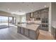 This spacious kitchen features stainless appliances, gray cabinets, and an island at 2194 Pigeon Hawk St, Las Vegas, NV 89138