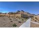 Sloped lot with desert landscaping features a sidewalk and tall mountains in the distance at 2194 Pigeon Hawk St, Las Vegas, NV 89138