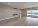 This bright living room features a sliding glass door and modern fireplace at 2194 Pigeon Hawk St, Las Vegas, NV 89138