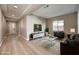 Bright living room with light floors, modern furniture, and recessed lighting at 2194 Pigeon Hawk St, Las Vegas, NV 89138