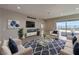 Open living room with city views, modern furniture, and a large area rug at 2194 Pigeon Hawk St, Las Vegas, NV 89138