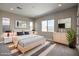 Stylish main bedroom with modern furniture, a large window, and neutral tones at 2194 Pigeon Hawk St, Las Vegas, NV 89138