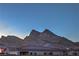 View of the mountains at dusk behind the rooftops at 2194 Pigeon Hawk St, Las Vegas, NV 89138