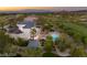 Aerial view of a luxury estate boasting a pool, outdoor firepit, lush landscaping, and manicured lawns at 22 Anthem Pointe Ct, Henderson, NV 89052