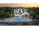 Aerial view of a backyard oasis featuring a sparkling pool, lush landscaping, and an expansive brick patio at 22 Anthem Pointe Ct, Henderson, NV 89052