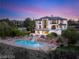 Aerial view of a luxury estate boasting a pool, waterfall, lush landscaping, and manicured lawns at 22 Anthem Pointe Ct, Henderson, NV 89052