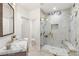 Marble bathroom features a glass shower and vanity with modern fixtures at 22 Anthem Pointe Ct, Henderson, NV 89052