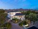 Grand estate featuring manicured landscaping, a circular driveway, and elegant architectural design at 22 Anthem Pointe Ct, Henderson, NV 89052