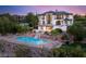 Stunning twilight view of estate featuring a sparkling pool, waterfall, and immaculate landscaping at 22 Anthem Pointe Ct, Henderson, NV 89052