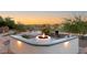 Cozy outdoor fire pit area with a water feature and beautiful landscaping with serene desert views at 22 Anthem Pointe Ct, Henderson, NV 89052