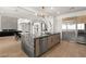 An open kitchen with a large island, stainless steel appliances, and a seamless flow to the living area at 22 Anthem Pointe Ct, Henderson, NV 89052