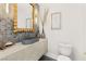 This powder room features designer mirror, vessel sink, and modern lighting at 22 Anthem Pointe Ct, Henderson, NV 89052