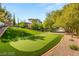 Beautiful home with a private putting green, surrounded by mature trees and lush landscaping at 22 Anthem Pointe Ct, Henderson, NV 89052