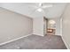 Neutral bedroom with carpet, ceiling fan, and connected bath area at 2200 S Fort Apache Rd # 2049, Las Vegas, NV 89117