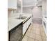Kitchen with white countertops, tile flooring, and modern appliances at 2200 S Fort Apache Rd # 2049, Las Vegas, NV 89117