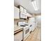 Well-lit kitchen with white cabinets and appliances and tile floors at 2200 S Fort Apache Rd # 2049, Las Vegas, NV 89117