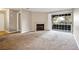 Carpeted living room with fireplace and sliding glass door to balcony at 2200 S Fort Apache Rd # 2049, Las Vegas, NV 89117